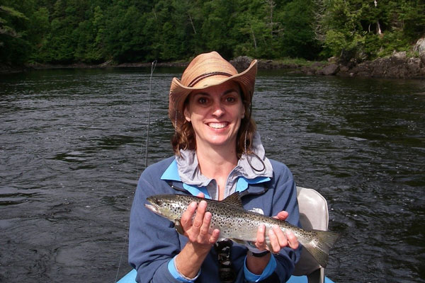 women with hat fly fishing