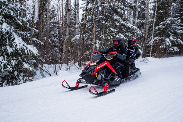 2 person Polaris snowmobile riding in maine